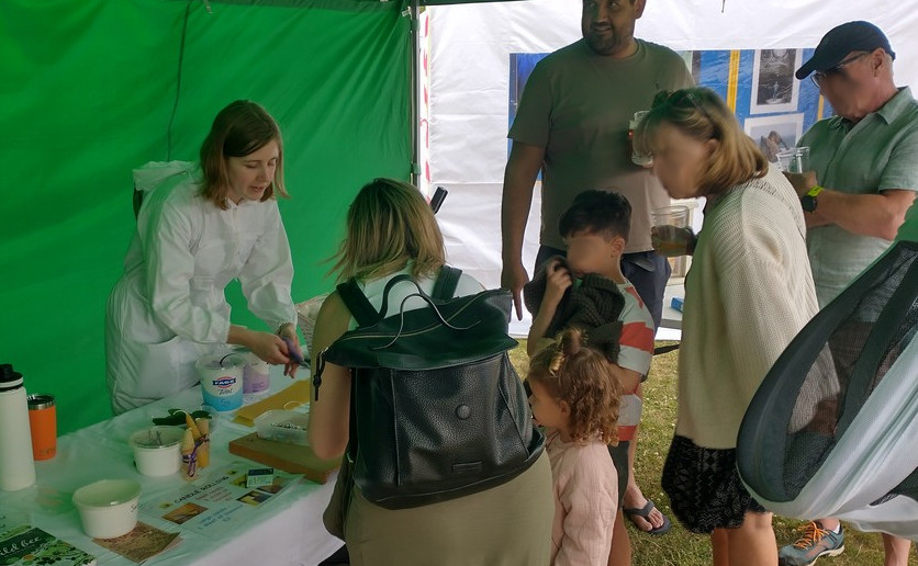 a family group standing at the candle rolling table